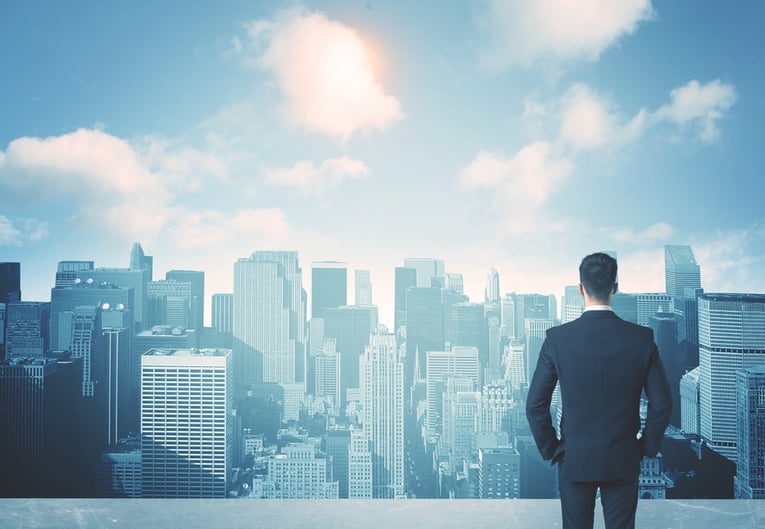 Businessman standing on a roof and looking at future city-1