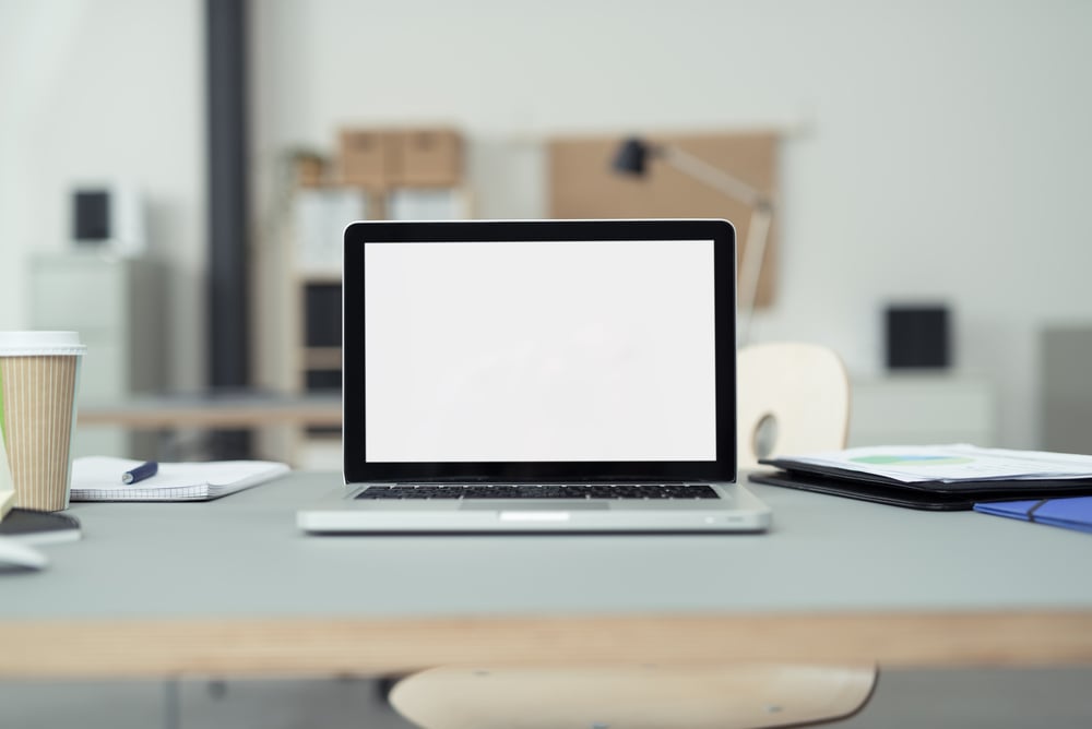 Close up Laptop Computer on Top of Office Table of a Businessman with Empty White Screen, Emphasizing Copy Space.-3