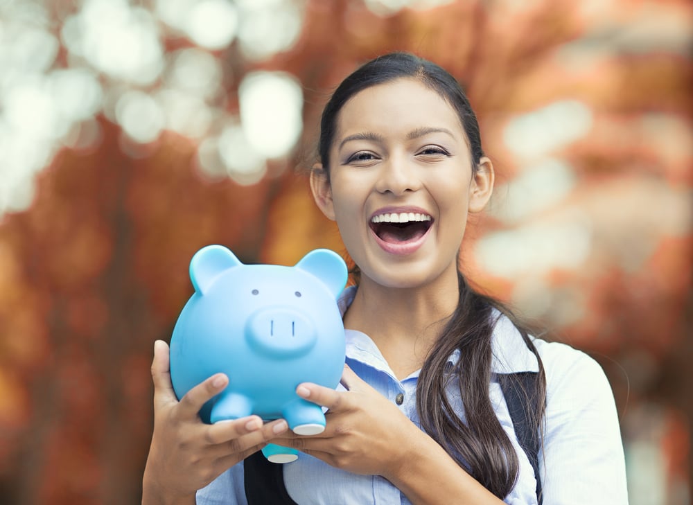 Closeup portrait happy, smiling business woman, bank employee holding piggy bank, isolated outdoors indian autumn background. Financial savings, banking concept. Positive emotions, face expressions-2