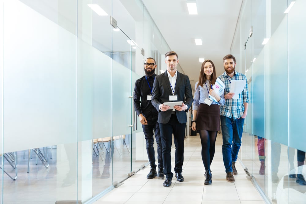 Full length of group of happy young business people walking the corridor in office together-Jan-11-2023-07-26-36-0355-AM