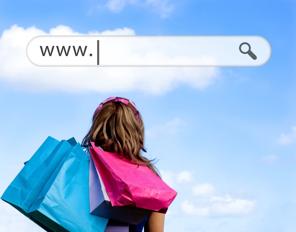 Girl holding shopping bags with address bar above against a blue sky