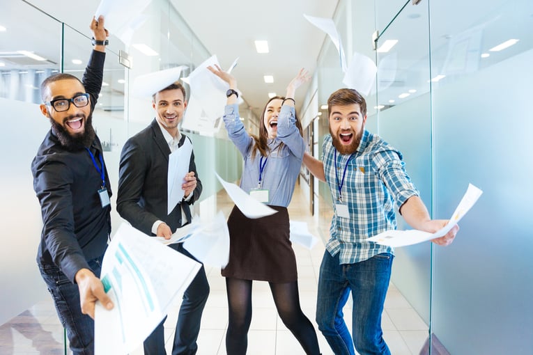 Group of joyful excited business people throwing papers and having fun in office-3