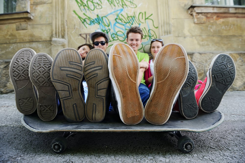 Urban stylish trendy young teenage people with legs on skate