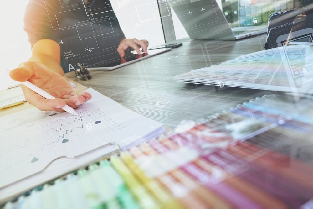 two colleagues interior designer discussing data and digital tablet and computer laptop with sample material and digital design diagram on wooden desk as concept-2