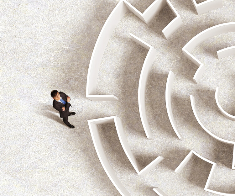 Top view of successful businessman standing near the entrance of labyrinth