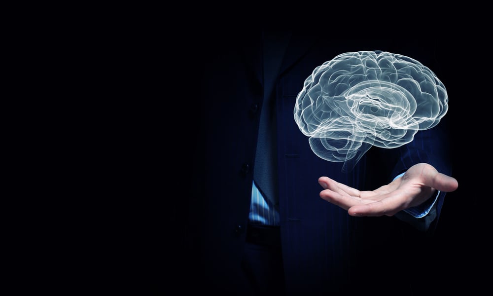 Close up of businessman hand holding brain in palm-1
